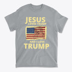 Jesus Loves Trump And I Love Trump graphic t-shirt featuring American flag design on a gray background.