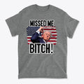 Missed Me Bitch Retro Graphic Design t-shirt featuring a bold graphic of a political figure and an American flag.
