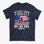 We Don't Know Them All But We Owe Them All On American Flag t-shirt design featuring patriotic elements.