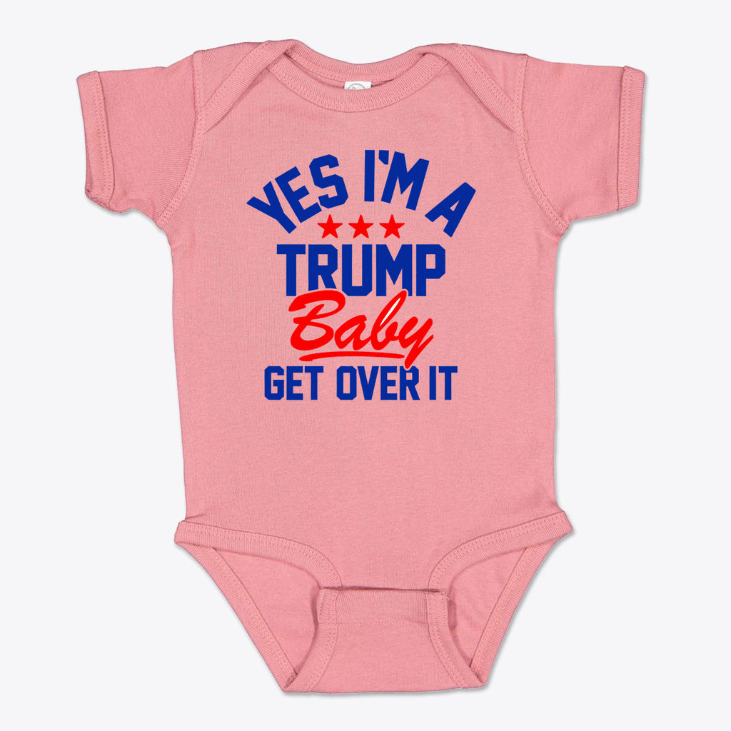 Yes I am A Trump Baby Onesie Art featuring a pink onesie with bold text saying 'YES I'M A TRUMP Baby GET OVER IT'