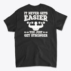 Back Print Never Gets Easier Fit graphic tee featuring motivational quote on the back in bold white letters.