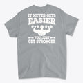 Back Print Never Gets Easier Fit t-shirt with motivational fitness quote on gray background.