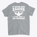 Back Print Never Gets Easier Fit t-shirt with motivational fitness quote on gray background.