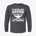 It Never Gets Easier Get Strong long sleeve graphic tee featuring a fitness-themed design.