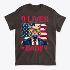 Nine Lives Baby Red Letters Art graphic tee featuring a cat in a suit against an American flag background.