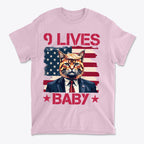 Nine Lives Baby Red Letters Art graphic tee featuring a cat in a suit against an American flag background.