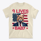 Nine Lives Baby Red Letters Art graphic tee featuring a cat in a suit against an American flag background.