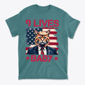 Nine Lives Baby Red Letters Art graphic tee featuring a cat in a suit against an American flag background.