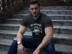 Man sitting on stairs wearing a 2nd Amendment U.S.A. Est. 1791 graphic t-shirt.