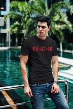 Model wearing 45 Plus 47 Equals 48 Red Letters graphic tee by a poolside.