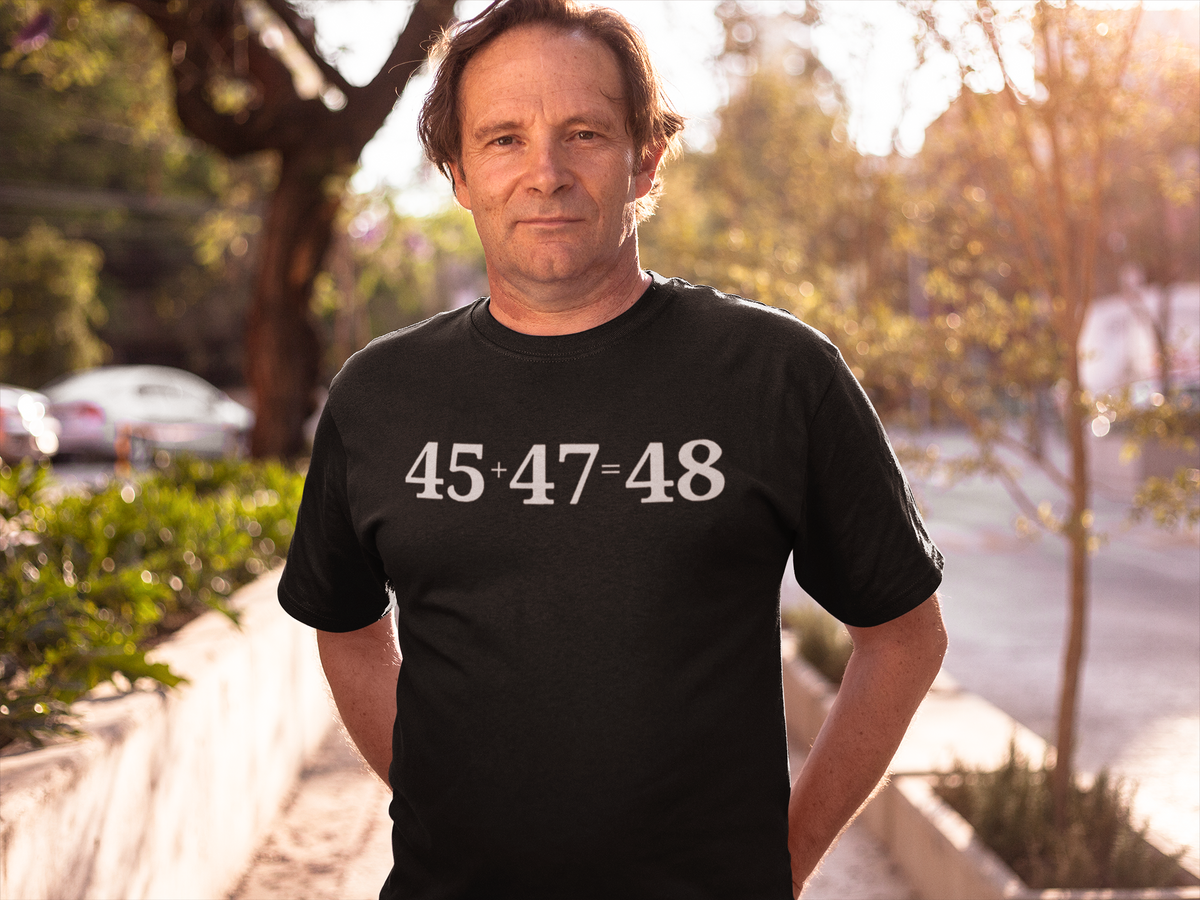 Man wearing 45 47 Equals 48 Red Letter Style graphic tee in a sunny outdoor setting.