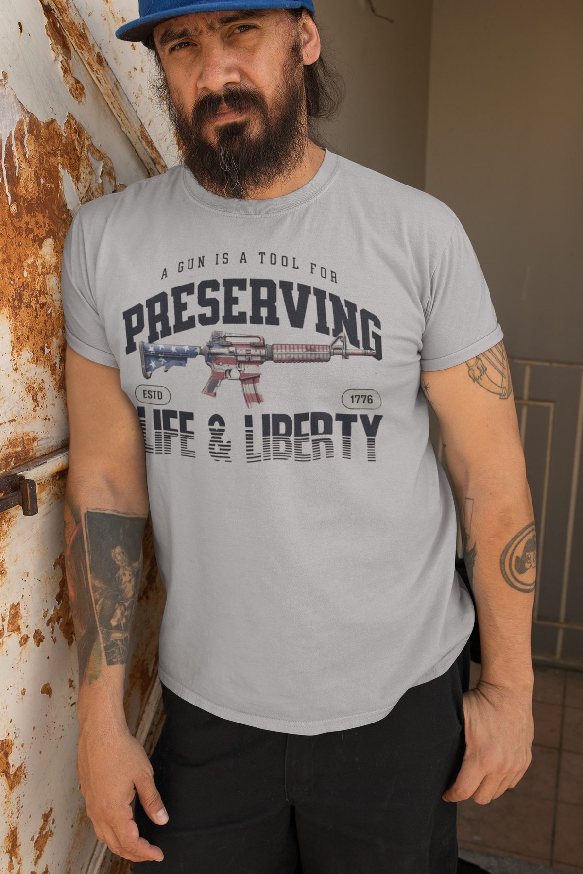 A Gun Is A Tool For Preserving Life and Liberty graphic tee worn by a man, showcasing personal beliefs and values.