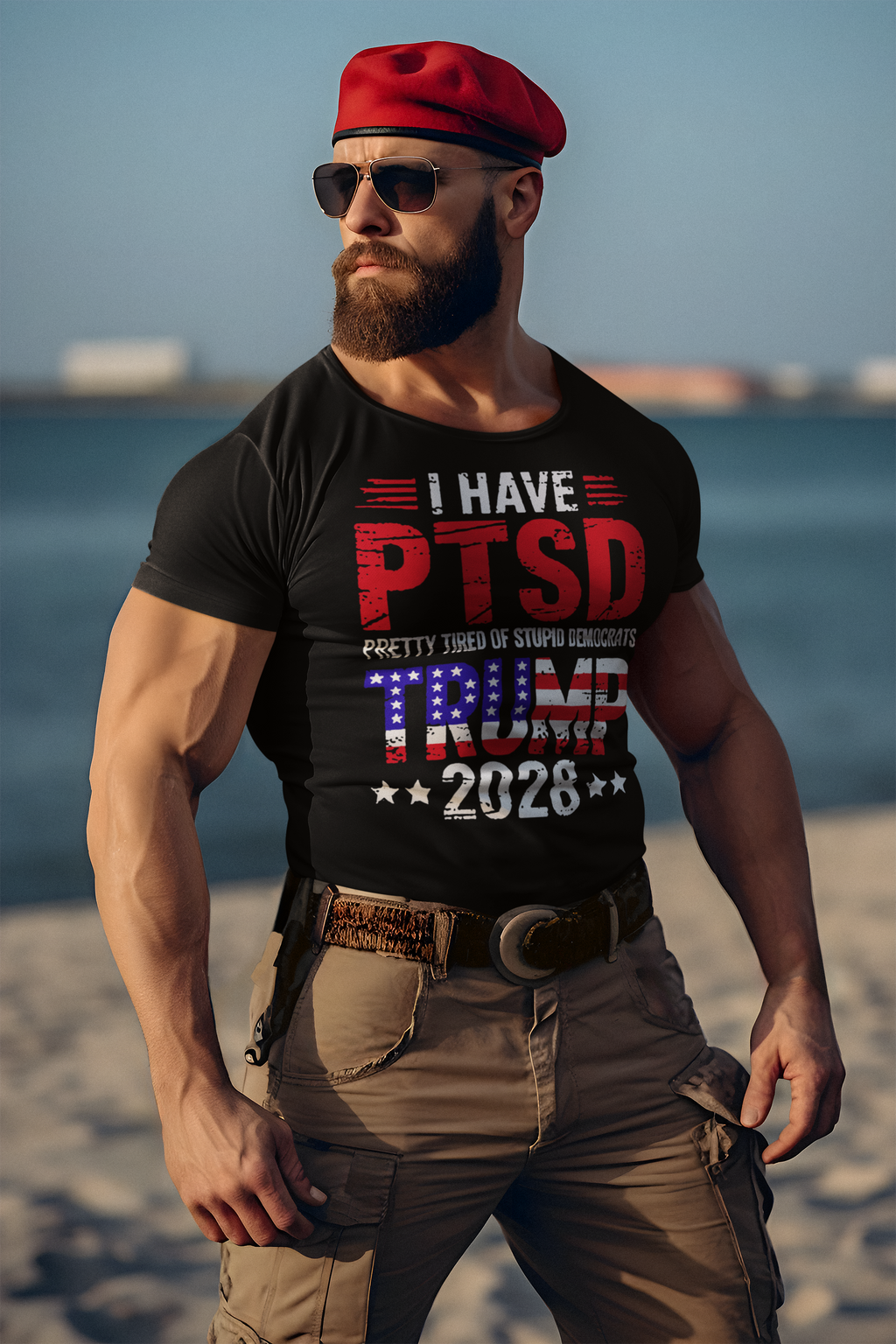 A man wearing a T-shirt with the phrase I Have PTSD Pretty Tired Of Stupid Democrats Trump 2028 on a beach.