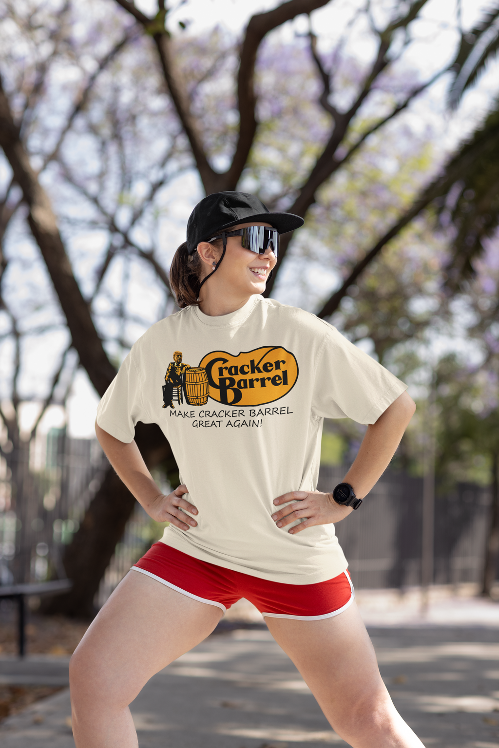 Woman in Cracker Barrel shirt posing outdoors, features text 'MAKE CRACKER BARREL GREAT AGAIN!'