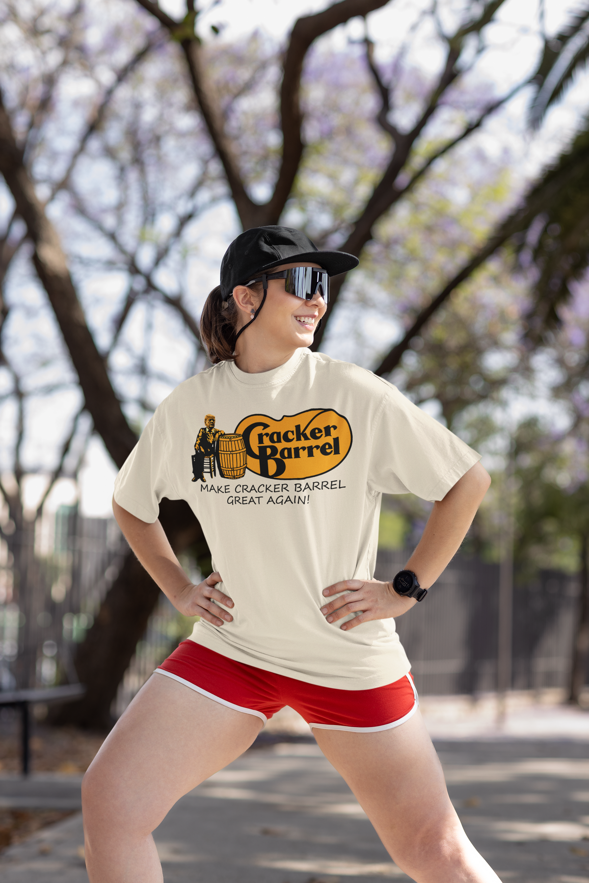Woman in Cracker Barrel shirt posing outdoors, features text 'MAKE CRACKER BARREL GREAT AGAIN!'