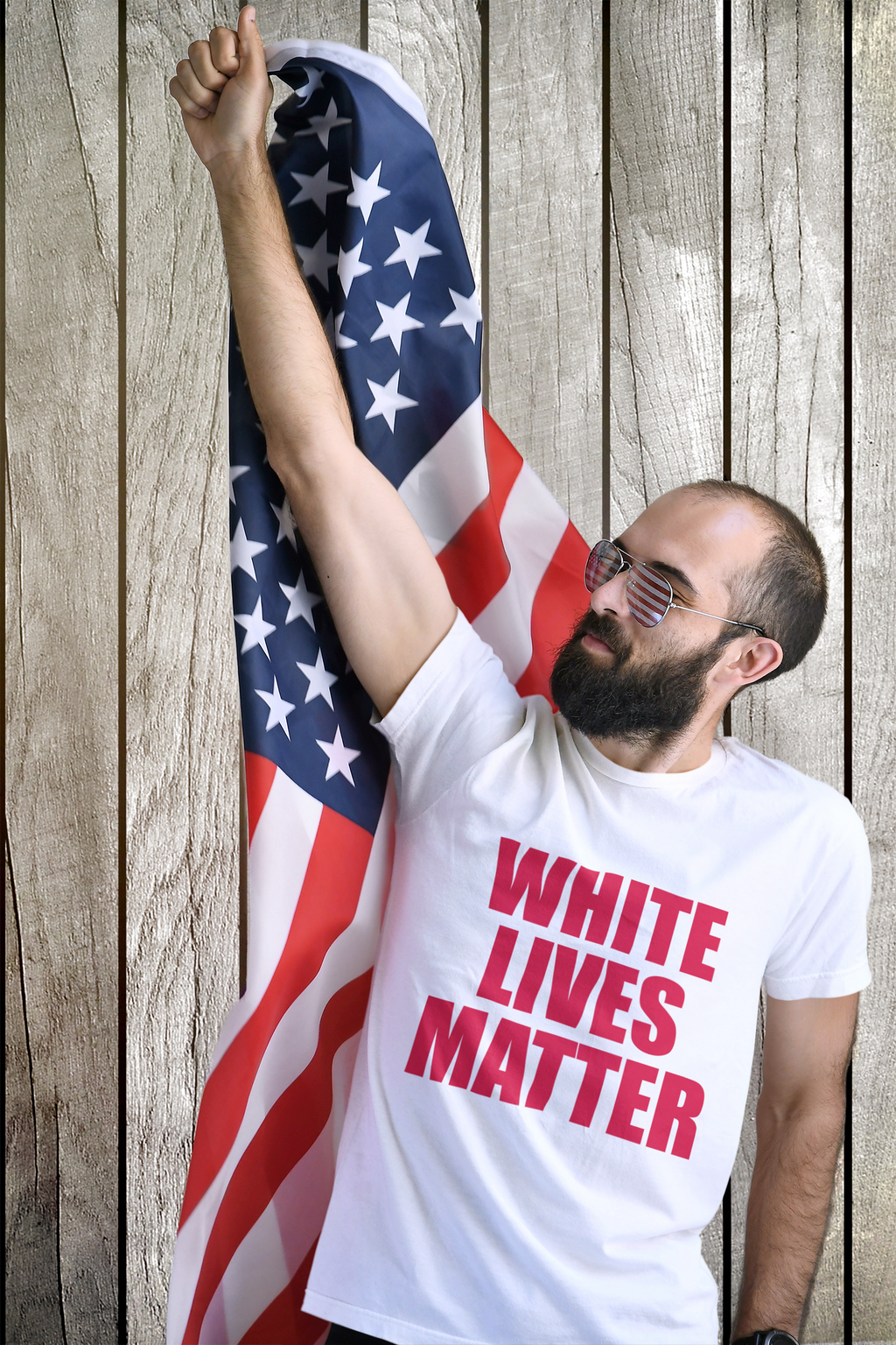Man wearing Equality Matters Black and White Design Tee holding flag.