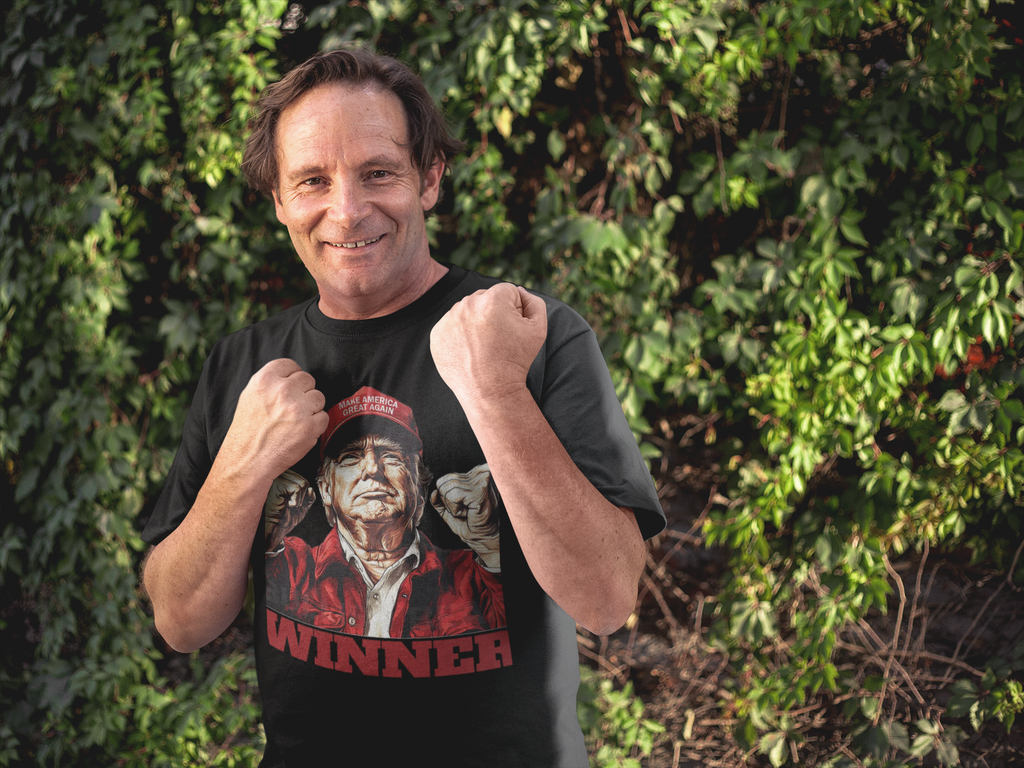 Man wearing Trump The Winning Choice Apparel t-shirt, celebrating a conservative message in a vibrant outdoor setting.