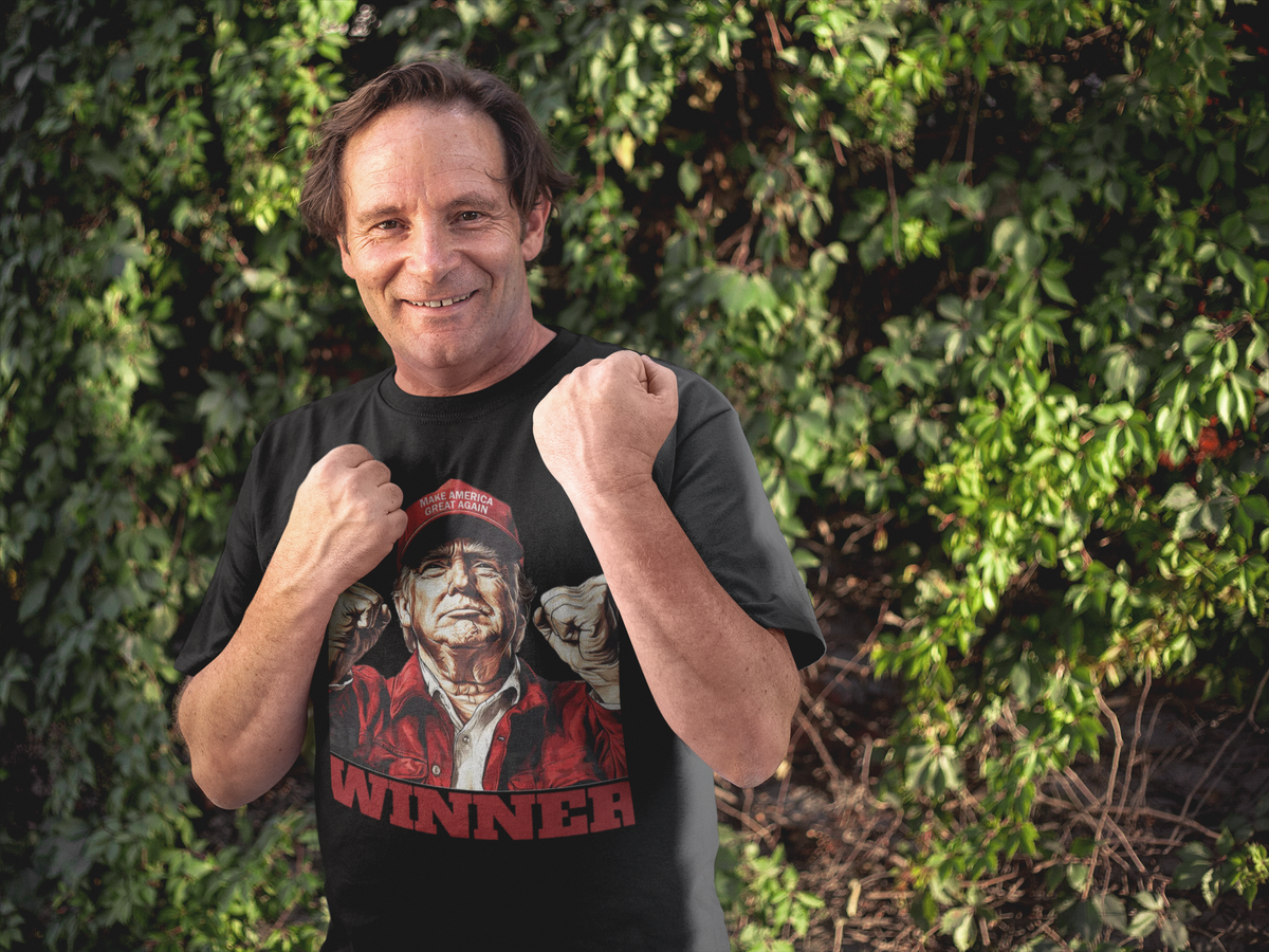 Man wearing Trump The Winning Choice Apparel t-shirt, celebrating a conservative message in a vibrant outdoor setting.