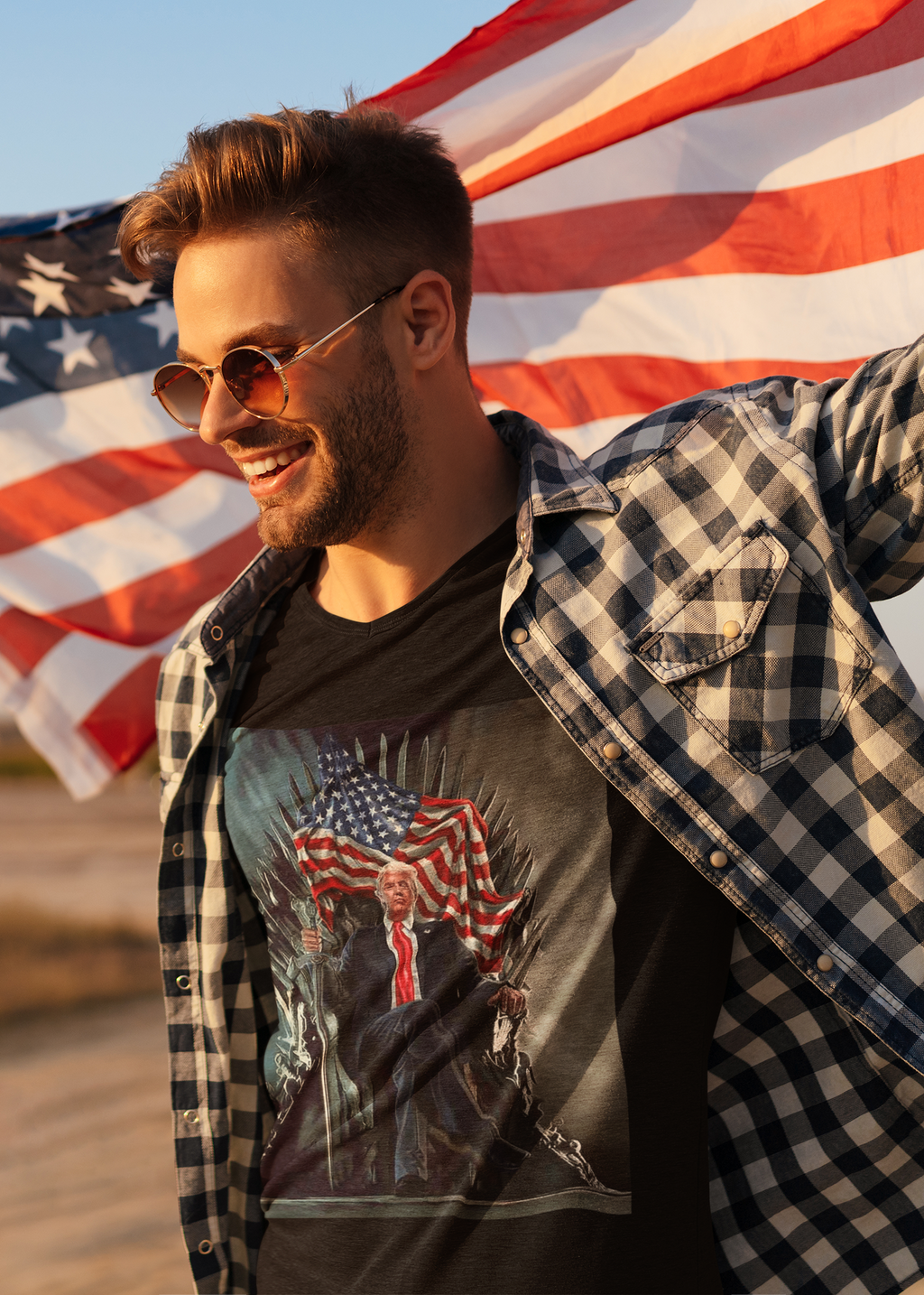 Man wearing Trump On Throne American Flag Tee, smiling with American flags in the background.