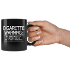 Health Warning Government Statement Graphic on black ceramic mug with text "CIGARETTE WARNING: GOVERNMENT IS DANGEROUS TO YOUR HEALTH!"