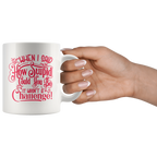 Coffee mug with 'When I Said How Stupid Could You Be It Wasn't A Challenge' humorous message held by a hand.