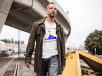 Man wearing 'All Gave Some Some Gave All Soldiers Flag Patriotic Tee' standing outdoors by a bridge.