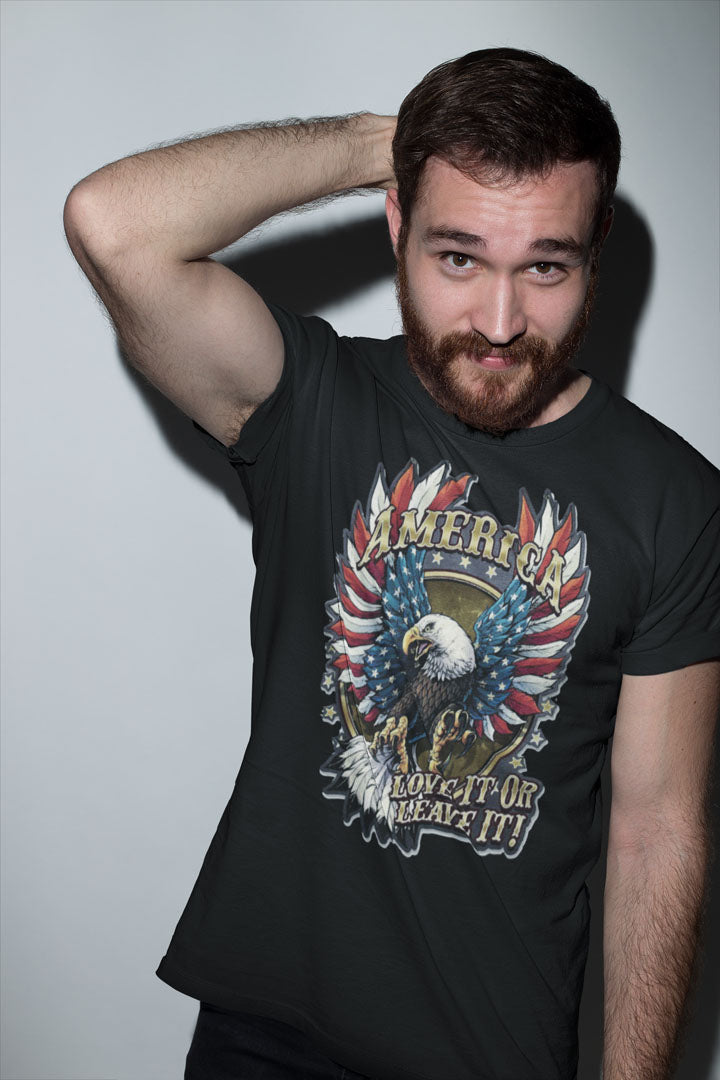 Man wearing America Love It Or Leave It Graphic Design t-shirt with eagle print, showcasing national pride and style.