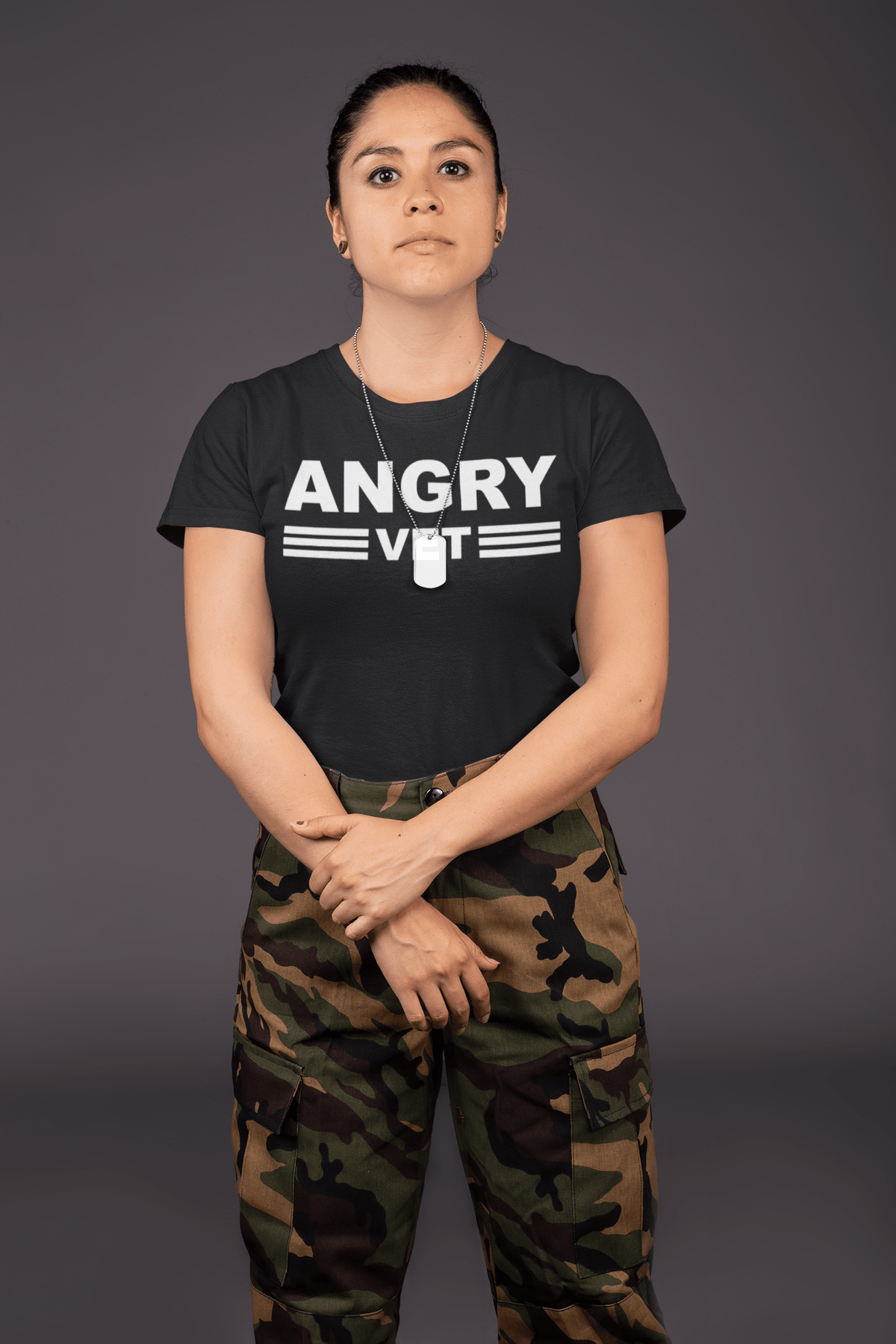 Woman wearing an Angry Vet Bold Funny Graphic Tee with camo pants in a strong pose.