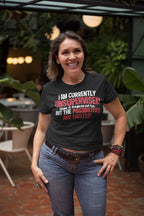 Woman wearing "Unsupervised and Full of Possibilities Tee" in a tropical setting, showcasing independence and adventurous spirit.