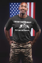 Person wearing 'I Do Not Fear The Valley For I Am The Shadow' graphic tee with an American flag in the background.