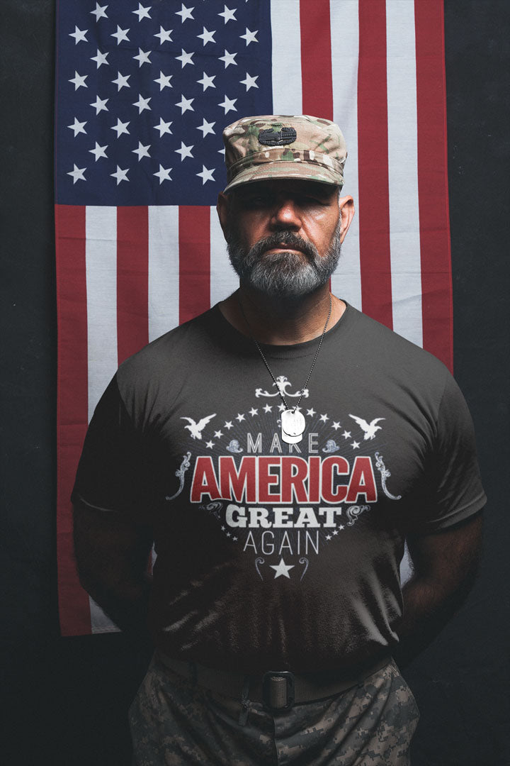 Man wearing Make America Great Again Bold Statement Design shirt in front of American flag.