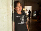 Woman wearing Statement Quote Typography Graphic Tee with bold text and image in a cozy room setting.