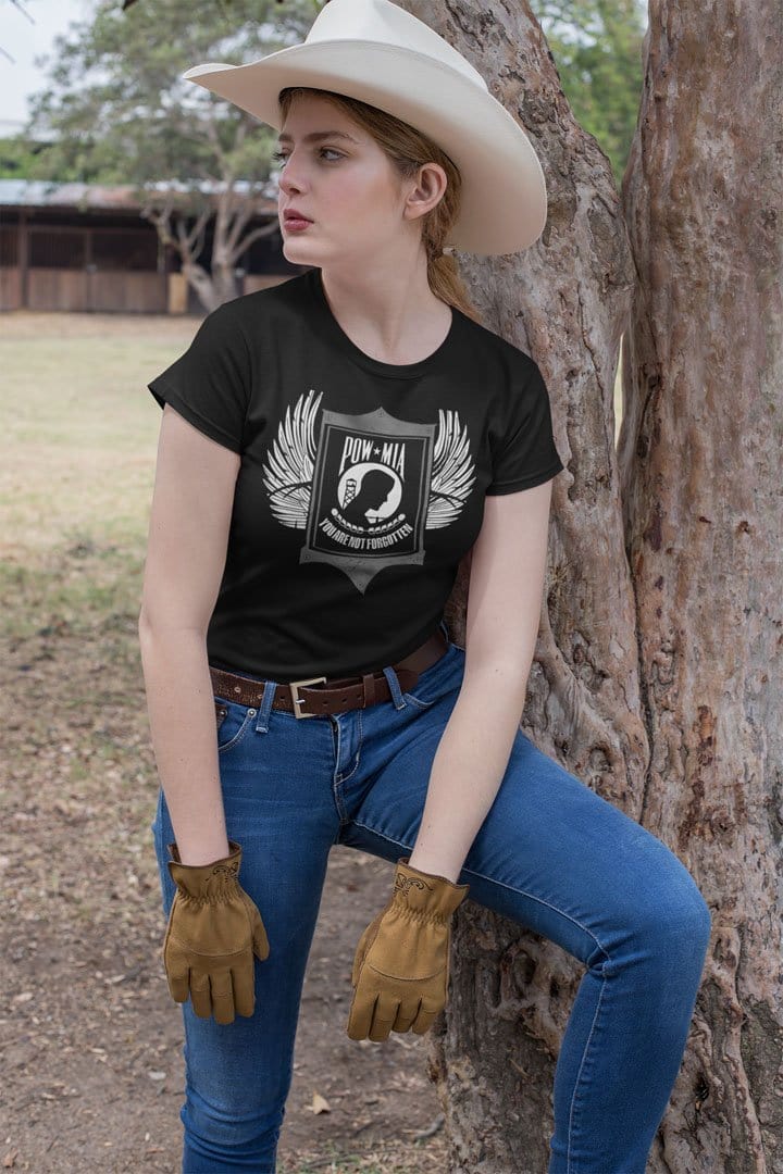 Woman wearing 'We Remember All Our POW MIA Heroes' graphic t-shirt outdoors