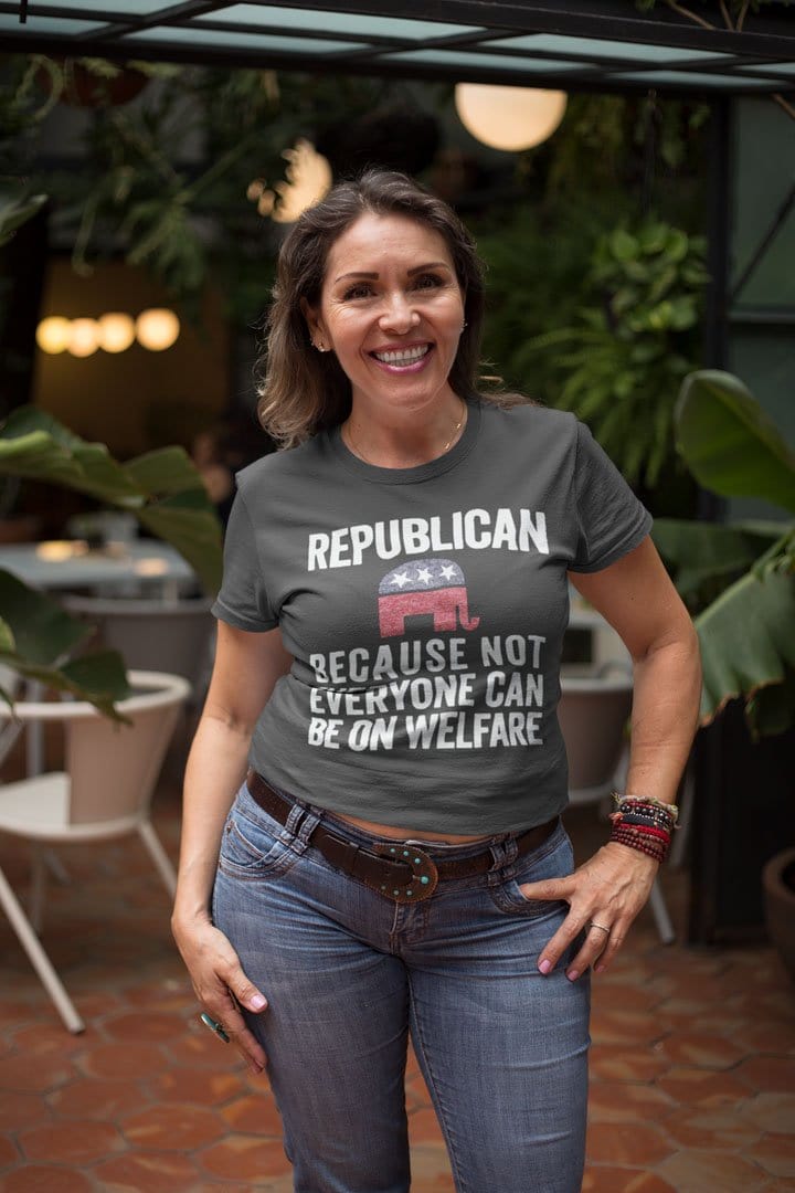 Woman wearing a t-shirt with Republican Because Not Everyone Can Be On Welfare slogan in a cafe setting.