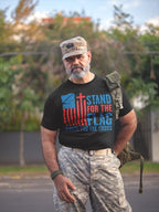 Man wearing Stand For The Flag Kneel For The Cross shirt, symbolizing patriotism and values.