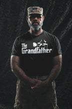 Man wearing The Grandfather Statement T-Shirt showcasing bold typography and military style.