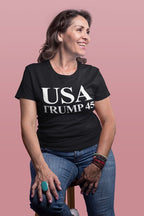 Smiling woman wearing USA 45 Trump Patriotic Supporter Graphic Tee Shirt, showcasing political enthusiasm and patriotic spirit.