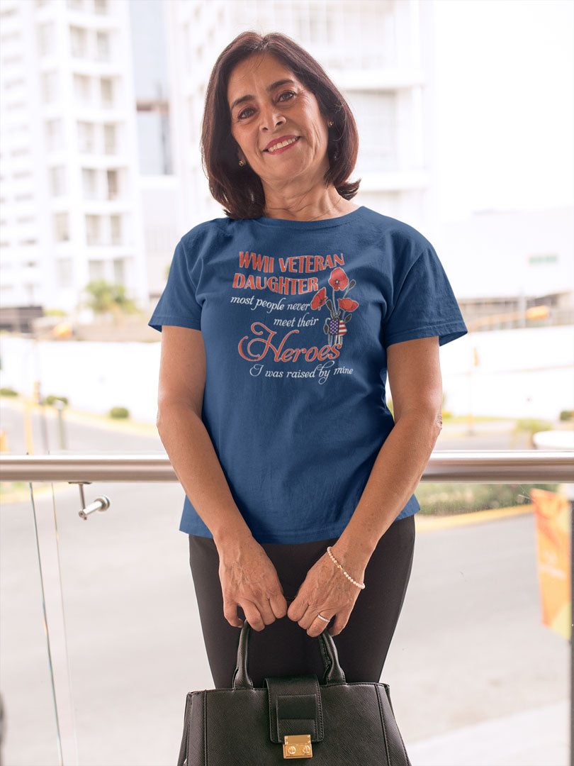 Woman wearing WWII Veteran Daughter Raised by My Hero Design t-shirt, standing outside holding a handbag.