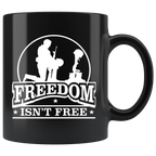 Freedom Isn't Free Patriotic Graphic Tee design on a black coffee mug showcasing respect for sacrifice with bold typography and motifs.