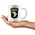 Hand holding a mug with Airborne Eagle Symbol Patriotic Graphic design