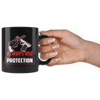 Black ceramic mug with 'Always Use Protection Statement Graphic' design held by hand, featuring premium ORCA coating.
