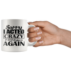 Hand holding a mug with Sorry I Acted Crazy Statement Design in bold text.
